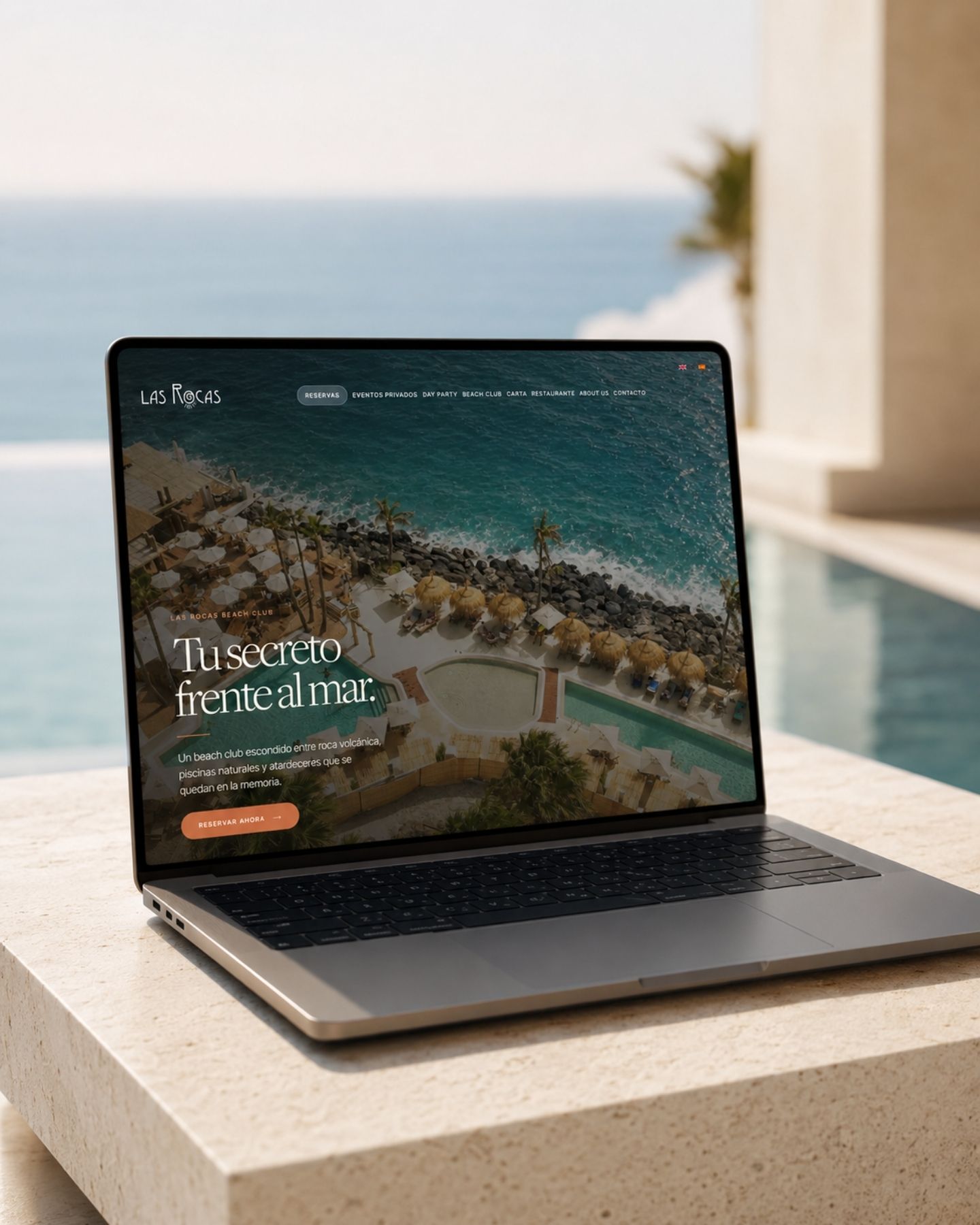Web de Las Rocas Beach Club en portátil junto al mar: dirección de marca y diseño web premium para un beach club en Tenerife, por A-ESTUDIO
